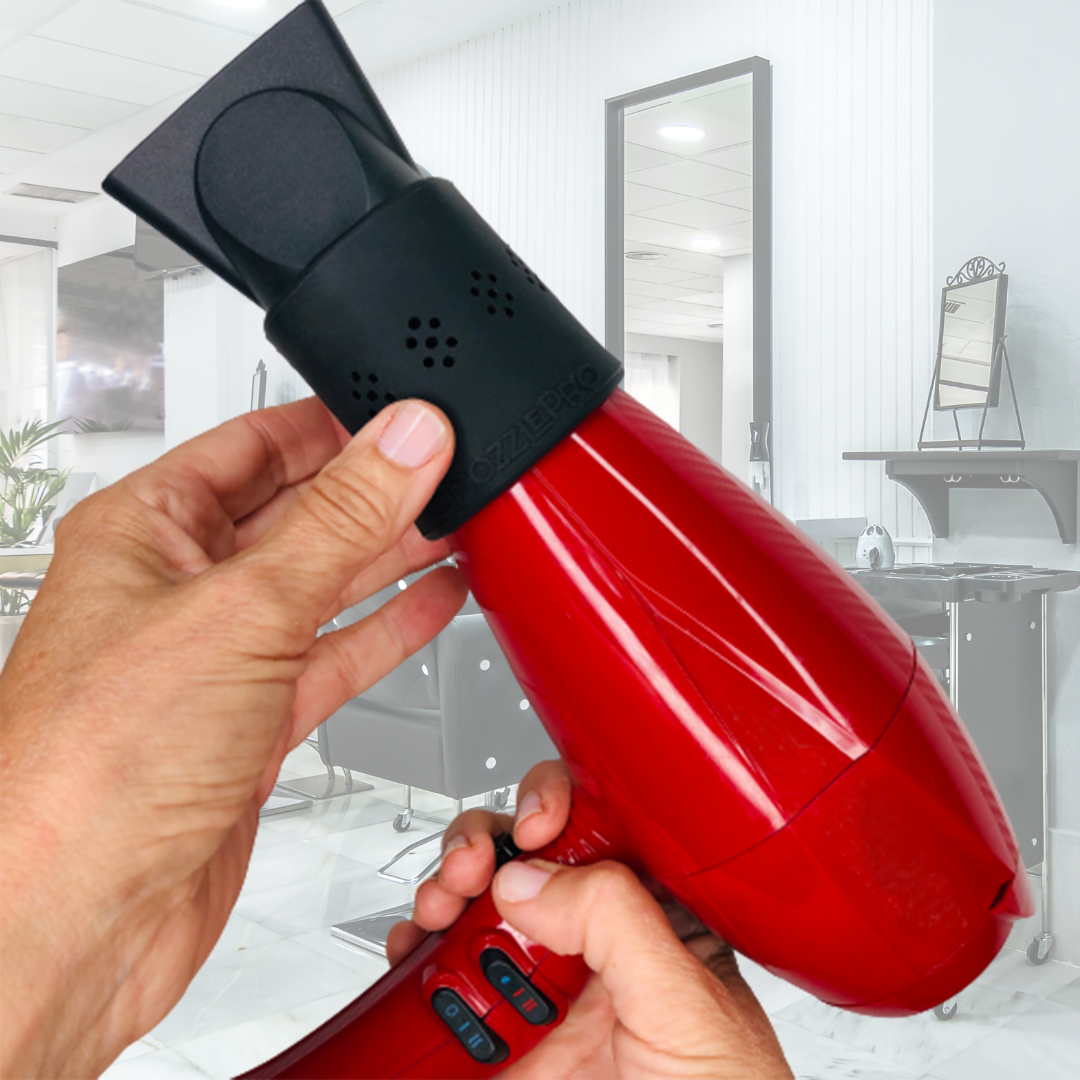 Hands holding a red hair dryer with a SnozzlePro concentrator nozzle attachment